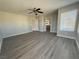Bright main bedroom featuring plank flooring, neutral gray walls, and a large window at 258 Bella Matese Ave, Las Vegas, NV 89183