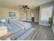 Light-filled main bedroom showcasing plank flooring, neutral gray walls, and a large window at 258 Bella Matese Ave, Las Vegas, NV 89183