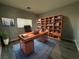 Inviting home office with a large desk, built-in bookcase, and natural light at 258 Bella Matese Ave, Las Vegas, NV 89183