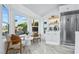 Light filled breakfast nook with modern seating and view of the landscaped outdoors at 2652 Golfside Dr, Las Vegas, NV 89134