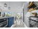 Well-lit kitchen featuring a breakfast bar, stainless steel appliances, and stylish finishes at 2652 Golfside Dr, Las Vegas, NV 89134