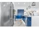 Spacious kitchen with stainless steel appliances, blue cabinetry, and modern pendant lighting at 2652 Golfside Dr, Las Vegas, NV 89134
