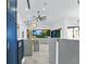 Open-concept living area with marble floors, modern lighting, and kitchen with blue cabinetry at 2652 Golfside Dr, Las Vegas, NV 89134