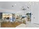 Open floor plan with marble floors leading to the living room, outdoor dining and kitchen with island seating at 2652 Golfside Dr, Las Vegas, NV 89134