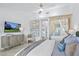 Stylish primary bedroom boasting a modern TV, ensuite bath, and stylish decor at 2652 Golfside Dr, Las Vegas, NV 89134