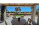 Covered patio with an outdoor dining area overlooking a manicured lawn and landscaped backyard at 2652 Golfside Dr, Las Vegas, NV 89134