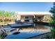 Luxury pool with lounge chairs, a covered patio, and views of the well landscaped backyard at 2655 Juniper Branch St, Las Vegas, NV 89117