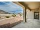 Covered patio overlooking the xeriscaped backyard with desert plants and mountain views at 2721 Faiss Dr, Las Vegas, NV 89134