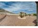 Backyard featuring desert landscaping, a block wall, and mountain views in the distance at 2721 Faiss Dr, Las Vegas, NV 89134
