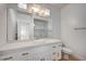 Bright bathroom with marble countertop, white cabinets and large mirror at 2721 Faiss Dr, Las Vegas, NV 89134