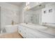 Bright bathroom featuring dual sinks, marble counter tops, soaking tub and glass shower at 2721 Faiss Dr, Las Vegas, NV 89134