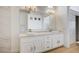 Bathroom with double vanity, marble countertop, and two sinks with gold fixtures at 2721 Faiss Dr, Las Vegas, NV 89134