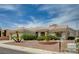 Inviting single-story home with desert landscaping, mature bushes, and mountain views in the background at 2721 Faiss Dr, Las Vegas, NV 89134