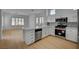 Well-lit kitchen with white cabinets, stainless steel appliances, and bar stool seating at 2721 Faiss Dr, Las Vegas, NV 89134