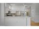 Modern kitchen with a breakfast bar, stainless steel appliances, and white cabinets at 2721 Faiss Dr, Las Vegas, NV 89134