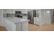 Modern kitchen featuring white cabinets, stainless steel appliances, and a breakfast bar at 2721 Faiss Dr, Las Vegas, NV 89134