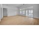 Bright and airy living room featuring wood floors, white walls, and large windows with plantation shutters at 2721 Faiss Dr, Las Vegas, NV 89134