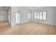 Bright living room featuring wood floors, large windows and a glass door leading to the outside at 2721 Faiss Dr, Las Vegas, NV 89134