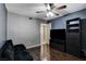 Bedroom showcasing hardwood floors, dark-colored furniture, a ceiling fan, and a large window at 2725 S Nellis Blvd # 1052, Las Vegas, NV 89121