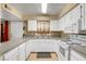 This eat-in kitchen features white cabinetry, sleek countertops, and a window at 2725 S Nellis Blvd # 1052, Las Vegas, NV 89121