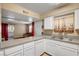 Open kitchen area with white cabinetry, tile floors, and a view to the living area at 2725 S Nellis Blvd # 1052, Las Vegas, NV 89121