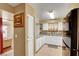 Bright kitchen with white cabinets, neutral countertops, and a view into the living room at 2725 S Nellis Blvd # 1052, Las Vegas, NV 89121