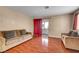 Living room with hardwood floors, neutral walls, and sliding doors to a balcony at 2725 S Nellis Blvd # 1052, Las Vegas, NV 89121