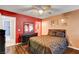 Main bedroom featuring wood floors and a dark furniture set against red accent walls at 2725 S Nellis Blvd # 1052, Las Vegas, NV 89121