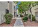 Exterior of the condo showing landscaped walkway lined with bushes and trees at 2725 S Nellis Blvd # 1052, Las Vegas, NV 89121
