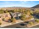 Stunning aerial view of the property showcasing the tile roof, three-car garage, and well-manicured landscaping at 28 Tea Olive Dr, Las Vegas, NV 89141