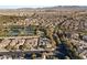 Wide aerial view of the community featuring mature trees, tennis courts, and mountain views at 28 Tea Olive Dr, Las Vegas, NV 89141