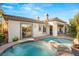 Backyard featuring a pool, spa, patio area, and lush landscaping for outdoor enjoyment at 28 Tea Olive Dr, Las Vegas, NV 89141