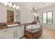 Luxurious bathroom features a soaking tub, elegant chandelier, and dual vanity sinks at 28 Tea Olive Dr, Las Vegas, NV 89141