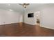 Open bedroom with hardwood floors and TV at 28 Tea Olive Dr, Las Vegas, NV 89141