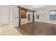 Dining room with stone accent wall, wood floors and a chandelier at 28 Tea Olive Dr, Las Vegas, NV 89141