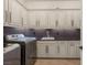 Well-equipped laundry room with modern washer, dryer, ample storage, and sleek countertop at 28 Tea Olive Dr, Las Vegas, NV 89141