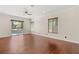 Spacious living room with hardwood floors and sliding doors to the pool at 28 Tea Olive Dr, Las Vegas, NV 89141