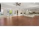 This expansive living room features hardwood floors, seamlessly connecting to a modern kitchen with an island and outdoor spaces at 28 Tea Olive Dr, Las Vegas, NV 89141
