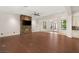 Expansive living space featuring hardwood floors, a stone accent fireplace, and direct access to outdoor areas at 28 Tea Olive Dr, Las Vegas, NV 89141