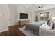 Staged main bedroom featuring a queen bed and sliding door to the pool at 28 Tea Olive Dr, Las Vegas, NV 89141