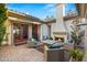 Cozy outdoor living space featuring a fireplace and comfortable seating, perfect for relaxation and entertaining al fresco at 28 Tea Olive Dr, Las Vegas, NV 89141