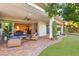 Expansive covered patio with comfortable seating area, ceiling fan, and access to the backyard at 28 Tea Olive Dr, Las Vegas, NV 89141