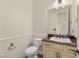 Cozy powder room with granite countertop, custom vanity and tile floor at 28 Tea Olive Dr, Las Vegas, NV 89141