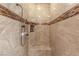 Elegant tiled shower includes a built-in bench seat and mosaic tile accents at 28 Tea Olive Dr, Las Vegas, NV 89141