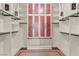 Spacious walk-in closet features custom shelving, cabinets with frosted glass, and ample storage space at 28 Tea Olive Dr, Las Vegas, NV 89141