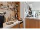 Close-up of a modern bar area featuring a marble countertop, a small sink, and open shelving at 2857 Paradise Rd # 2203, Las Vegas, NV 89109