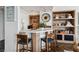 Stylish bar area with marble countertop, wooden cabinets, shelving, and modern stools at 2857 Paradise Rd # 2203, Las Vegas, NV 89109