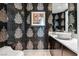 Powder room featuring decorative wallpaper, a marble countertop, and modern fixtures at 2857 Paradise Rd # 2203, Las Vegas, NV 89109