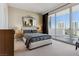 This bedroom boasts a large bed, a decorative mirror, and access to a balcony with views at 2857 Paradise Rd # 2203, Las Vegas, NV 89109