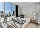 This bedroom features an upholstered bed, city views, and windows allowing lots of natural light at 2857 Paradise Rd # 2203, Las Vegas, NV 89109
